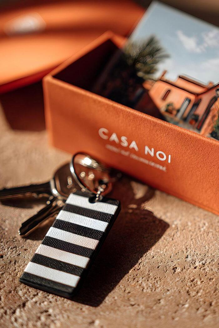Casa Noi — branded welcome box and key fob